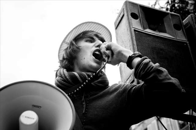 Man yells into megaphone speaker