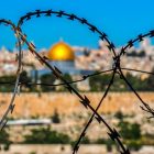 Barbed wire with Al-Asqa mosque in distance