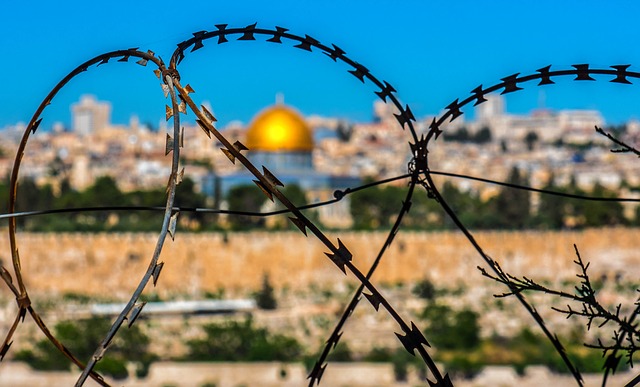 Barbed wire with Al-Asqa mosque in distance