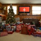 Image of large Christmas tree with a lot of presents underneath and around the tree