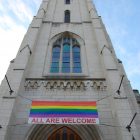 church with LGBTQ flag hanging in front