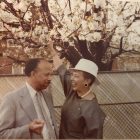 man and woman smiling by tree