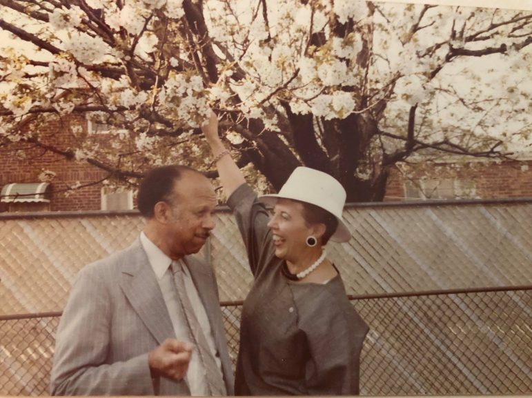 man and woman smiling by tree