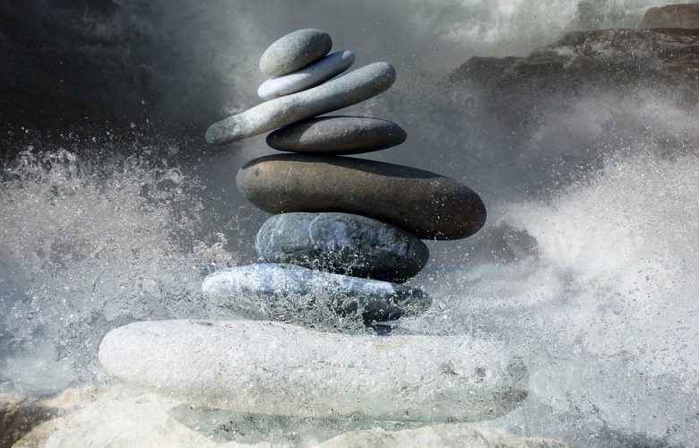 stones tacked on top of each other with water splashing