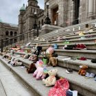 assorted plush toys on gray concrete road during daytime